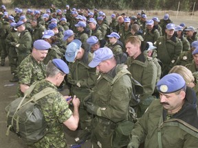 Canadian peacekeepers prepare auto atropine injectors during chemical defence refresher training at Camp Ziouani in the Golan Heights in 2002.