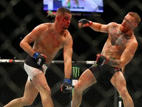 Nate Diaz punches Conor McGregor during UFC 196 at the MGM Grand Garden Arena.