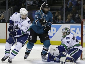 Vancouver Canucks goalie Jacob Markstrom  blocks a shot from San Jose Sharks' Joel Ward during the third period  in San Jose Saturday.