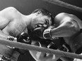 George Chuvalo, left, and Muhammad Ali trade blows near the rope in fourth round of their Toronto fight on March 29, 1966 in Toronto.