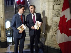 Prime Minister Justin Trudeau (left) speaks with Minister of Finance Bill Morneau as he arrives to table the budget on Parliament Hill, Tuesday, March 22, 2016 in Ottawa. THE CANADIAN PRESS/Justin Tang ORG XMIT: JDT103