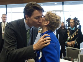 Prime Minister Justin Trudeau gives Ontario Premier Kathleen Wynne a kiss as he arrives for a meeting of the First Ministers, First Nations, Inuit, and Metis Leaders in Vancouver.