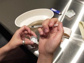 A man prepares heroin to be injected at the Insite safe injection clinic in Vancouver, B.C., on Wednesday May 11, 2011. Toronto is joining the growing list of Canadian cities - which includes Ottawa and Montreal - that plan to set up safe-injection sites.