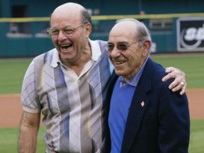 In this May 31, 2003, file photo, Joe Garagiola, left, and Yogi Berra share a moment after throwing out the first pitch before a game in St. Louis. Garagiola, a former big league catcher and popular broadcaster died at age 90 on Wednesday.