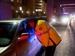 Police officers stop motorists during a RIDE program spot-check in Toronto.