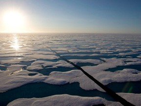 The midnight sun shines over the ice covered waters near Resolute Bay as seen from the Canadian Coast Guard icebreaker Louis S. St-Laurent, Saturday, July 12, 2008.