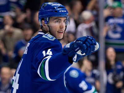 Alex Burrows waves to fans after him and his family drop the puck at  News Photo - Getty Images