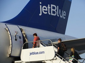 Travellers board a JetBlue Airways Corp. Airbus.