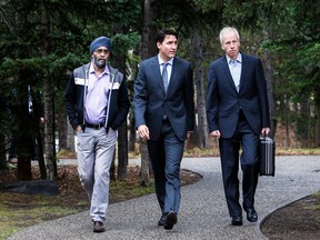 Prime Minister Justin Trudeau arrives with Minister of National Defence Harjit Sajjan, left, and Minister of Foreign Affairs Stephane Dion, right, for meetings at a Liberal Party cabinet retreat in Kananaskis, Alta., Monday, April 25, 2016.