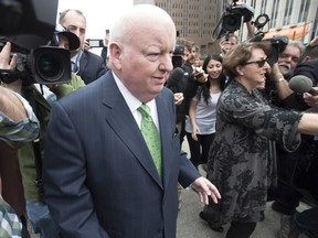 Sen. Mike Duffy leaves the courthouse with his wife Heather (right) after being acquitted on all charges, Thursday, April 21, 2016 in Ottawa.