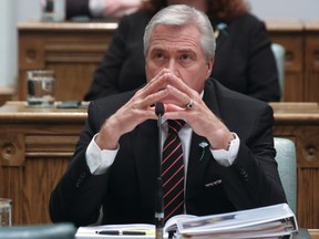 Newfoundland and Labrador Premier Dwight Ball listens as Finance Minister Cathy Bennett presents the 2016 provincial budget on April 14.