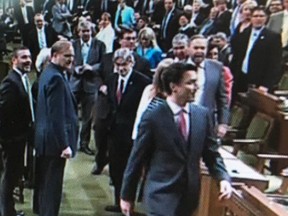 Prime Minister Justin Trudeau walks across the floor to engage Tom Mulcair in the House of Commons on May 18, 2016 in an incident later referred to as “elbowgate.”