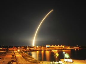 In this photo taken with a 73-second exposure, SpaceX's Falcon 9 rocket lights up the sky after a launch from the Cape Canaveral Air Force Station early Friday.