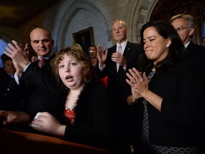 Charlie Lowthian-Rickert, who is transgender, speaks along side Justice Minister Jody Wilson-Raybould as she makes an announcement on Tuesday regarding legislation on gender identity and gender expression.