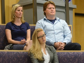 Andrea Brown, wife of London Mayor Matt Brown, sits with minister Jeff Crittenden, right, and press secretary Ashton Patis during a city council meeting at London City Hall