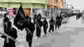 This undated file image posted on a militant website on Tuesday, Jan. 14, 2014 shows fighters ISIL marching in Raqqa, Syria