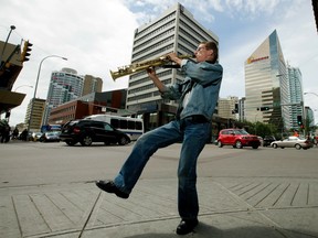 Busker Quinn Wade plays the soprano saxophone on a downtown street corner , in Edmonton on Thursday July 21, 2016.