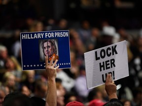 Delegates hold signs reading "Hillary For Prison" and "Lock Her Up" during the Republican National Convention (RNC) in Cleveland on Wednesday.