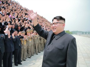 This undated picture released from North Korea's official Korean Central News Agency (KCNA) on June 29, 2016 shows North Korean leader Kim Jong-Un (C) attending a photo session with the contributors to the successful test-fire of the surface-to-surface medium long-range strategic ballistic rocket Hwasong-10, at an undisclosed location.