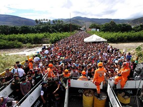 Venezuelans cross the Simon Bolivar bridge linking San Antonio del Tachira, in Venezuela with Cucuta in Colombia, to buy basic supplies on July 17, 2016