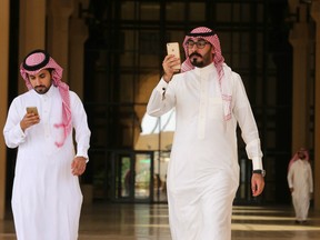 Saudi men play the Pokemon Go game on their mobile phones in Riyadh, Saudi Arabia on July 17, 2016