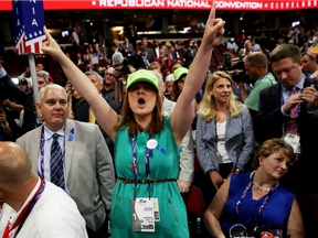 Diana Shores from Farmville, VA (C) protests a roll call vote on the floor on the first day of the Republican National Convention on July 18, 2016 at the Quicken Loans Arena in Cleveland, Ohio.