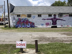 A mural acknowledging Alton Sterling is displayed on a wall near the Triple S Food Mart July 19, 2016 in Baton Rouge, Louisiana.