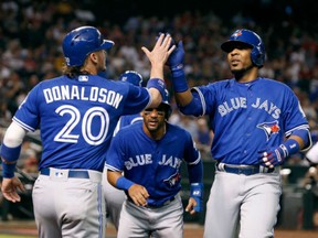 Edwin Encarnacion of the Toronto Blue Jays  is congratulated by teammate Josh Donaldson after hitting a three-run home run against the Arizona Diamondbacks on Wednesday. Encarnacion has 26 home runs on the season and Donaldson has 24.