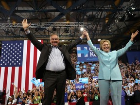 Democratic presidential candidate former Secretary of State Hillary Clinton and Democratic vice presidential candidate U.S. Sen. Tim Kaine (D-VA) greet supporters during a campaign rally at Florida International University Panther Arena on July 23, 2016 in Miami, Florida.