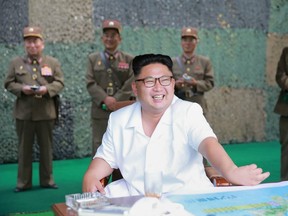 This undated photo released by North Korea's official Korean Central News Agency (KCNA) on July 21, 2016 shows North Korean leader Kim Jong-Un (C) smiling as he visits a drill for ballistic missile launch by the Hwasong artillery units of the Strategic Force of the Korean People's Army.
North Korea said on July 20 its latest ballistic missile tests trialled detonation devices for possible nuclear strikes on US targets in South Korea and were personally monitored by supreme leader Kim Jong-Un.