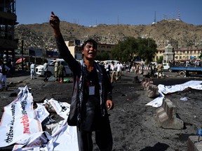 An Afghan protester screams near the scene of a suicide attack that targeted crowds of minority Shiite Hazaras during a demonstration at the Deh Mazang Circle in Kabul on July 23, 2016.