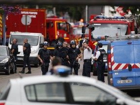 French police officers and fire engine arrive at the scene of a hostage-taking at a church in Saint-Etienne-du-Rouvray, northern France, on July 26, 2016 that left the priest dead.