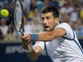 Novak Djokovic of Serbia returns the ball against Gael Monfils of France during men's semifinal action at the Rogers Cup in Toronto on Saturday night.