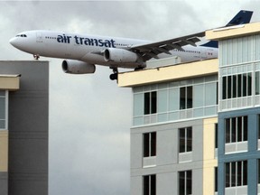 An Air Transat flight comes in for a landing behind the Calgary Airport Hotels and Conference Centre  buildings. One Air Transat flight that won't be coming in to land just yet is TS725, which was delayed a day after two pilots were arrested at Glasgow airport on suspicion of being intoxicated