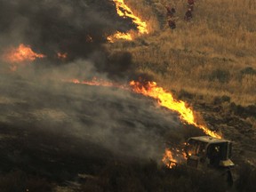 Two massive wildfires raged in tinder-dry California hills.