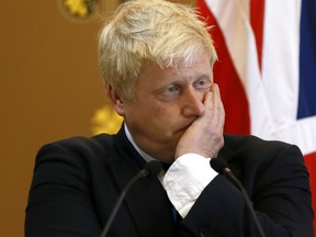 Britain's Foreign Secretary Boris Johnson listens as U.S. Secretary of State John Kerry speaks during a press conference at the Foreign Office in London, Tuesday, July 19, 2016