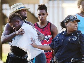 People embrace after a fatal shooting at Club Blu in Fort Myers, Fla., Monday, July 25, 2016.