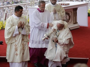 Pope Francis is helped by Vatican Master of Ceremonies, Mons. Guido Marini as he stumbles on the altar as he celebrates a mass in Czestochowa, Poland, Thursday, July 28, 2016.