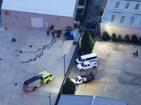 In this aerial photo, investigators work part of the shooting scene in Baton Rouge, La., where law enforcement officers were injured and killed, Sunday, July 17, 2016.