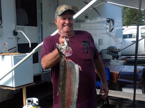 Ron Lancour, the B.C. man who fended off the badger attack, with a 3.5-kg rainbow trout he caught in Sheridan Lake this week.