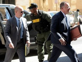 Lt. Brian Rice, left, one of the six members of the Baltimore Police Department charged in connection to the death of Freddie Gray, arrives in court in Baltimore on July 18.