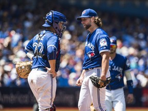 Toronto Blue Jays pitcher R.A. Dickey talks to catcher Josh Thole before being pulled against the San Diego Padres during sixth inning on Wednesday, July 27, 2016.