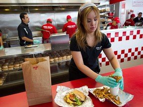 Cookie Bastos wraps up an order to go at the Five Guys restaurant in Dublin, California, on June 29, 2011.
