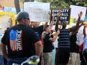 A Blue Lives Matter movement supporter, wearing a Donald Trump for president T-shirt, watches Black Live Matter protesters in McAllen, Texas, earlier this month.