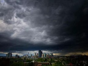 A thunderstorm moves in over downtown Calgary, Alta., on Saturday July 30, 2016