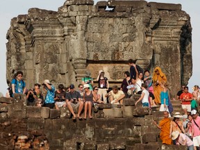 Tourists gather on the top of the 10th-century temple Bakheng in the Angkor Wat complex to view the setting sun.