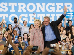 Hillary Clinton, presumptive 2016 Democratic presidential nominee, acknowledges supporters with Senator Tim Kaine, a Democrat from Virginia, during a campaign event at Northern Virginia Community College in Annandale, Virginia, U.S., on Thursday, July 14, 2016. Bill Clinton has tipped Kaine to be his wife's vice presidential selection