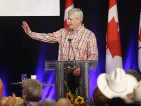 Former Prime Minister Stephen Harper makes a speech during the Calgary Stampede in July, 2016, a couple of weeks before Powell's hacked emails say he visited Bohemian Grove.