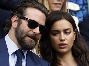 In this July 10, 2016, file photo, actor Bradley Cooper, left, speaks with his girlfriend model Irina Shayk on the fourteenth day of the Wimbledon Tennis Championships in London.