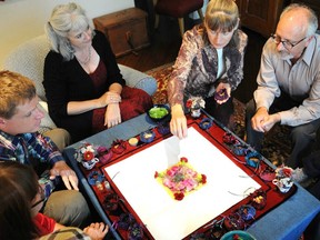 Sarah Kerr, back left, performs a ceremony with the family of one of her clients.